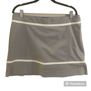Women’s adidas golf skirt with built-in shorts.  Gray with white trim, size 12.